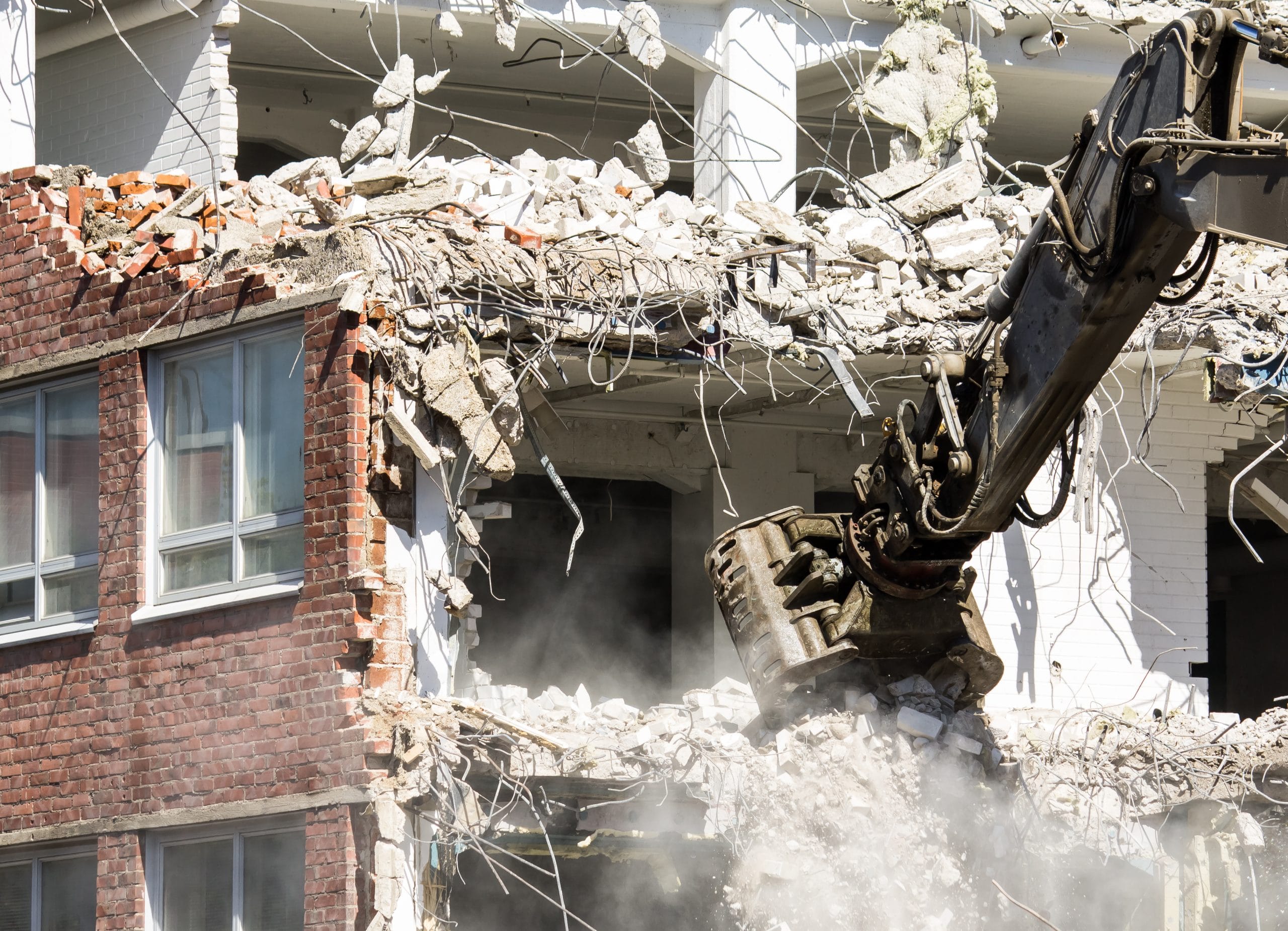 Demolition of a building in progress - claw moving rubble