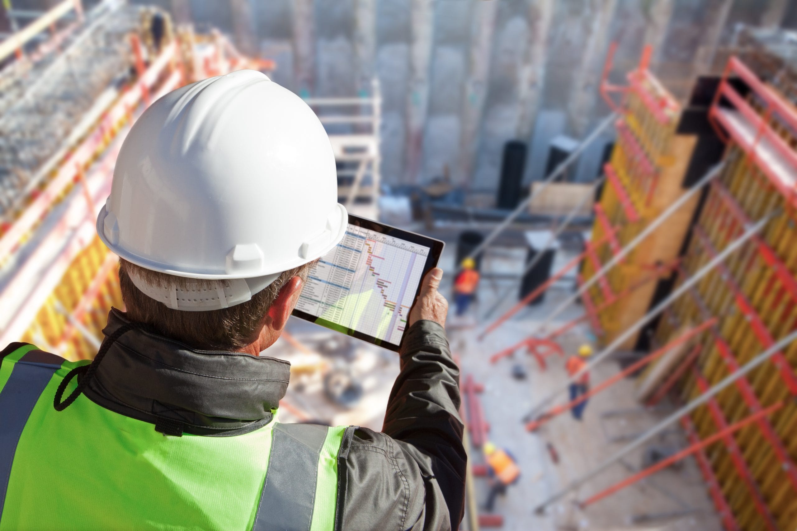 Construction Site Manager checking the programme as he oversees the construction site.