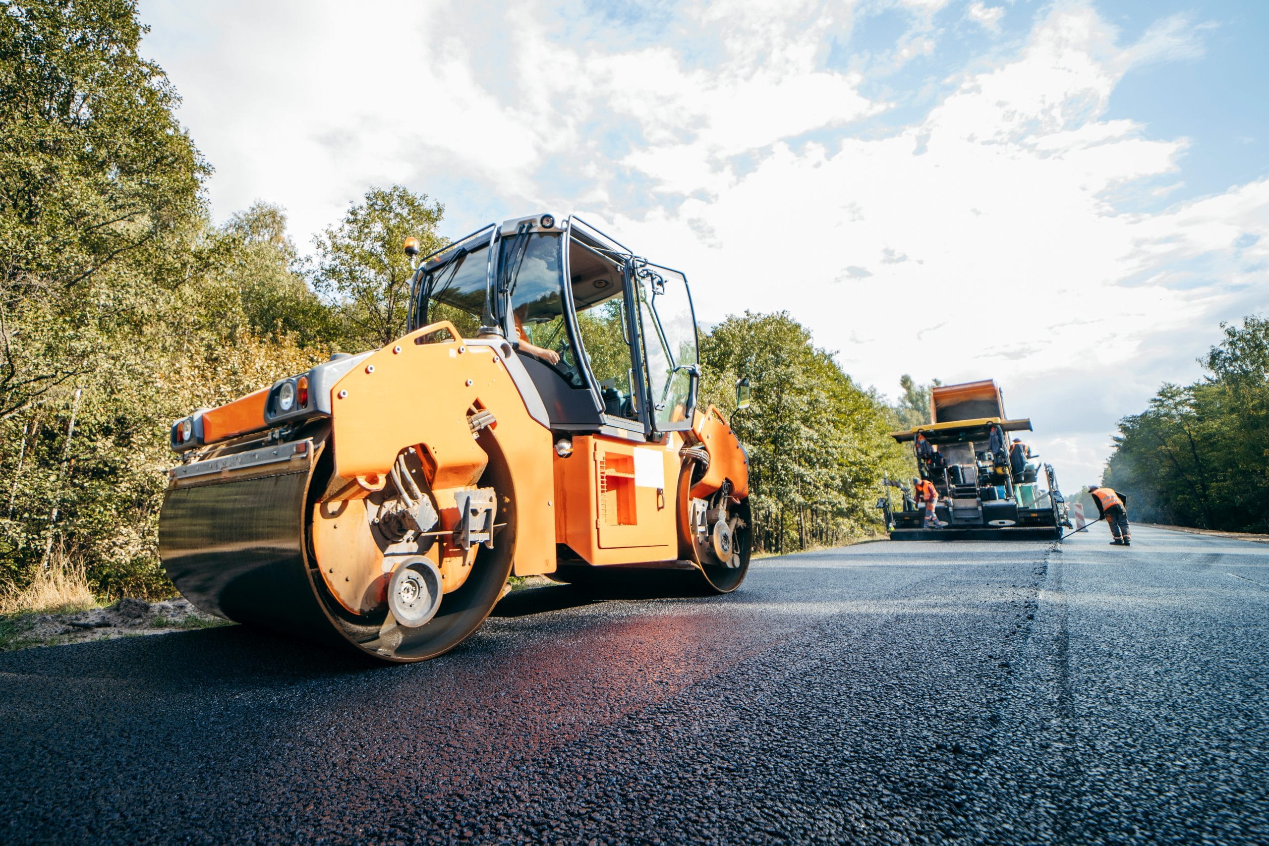 Ride-on roller compacting new asphalt road