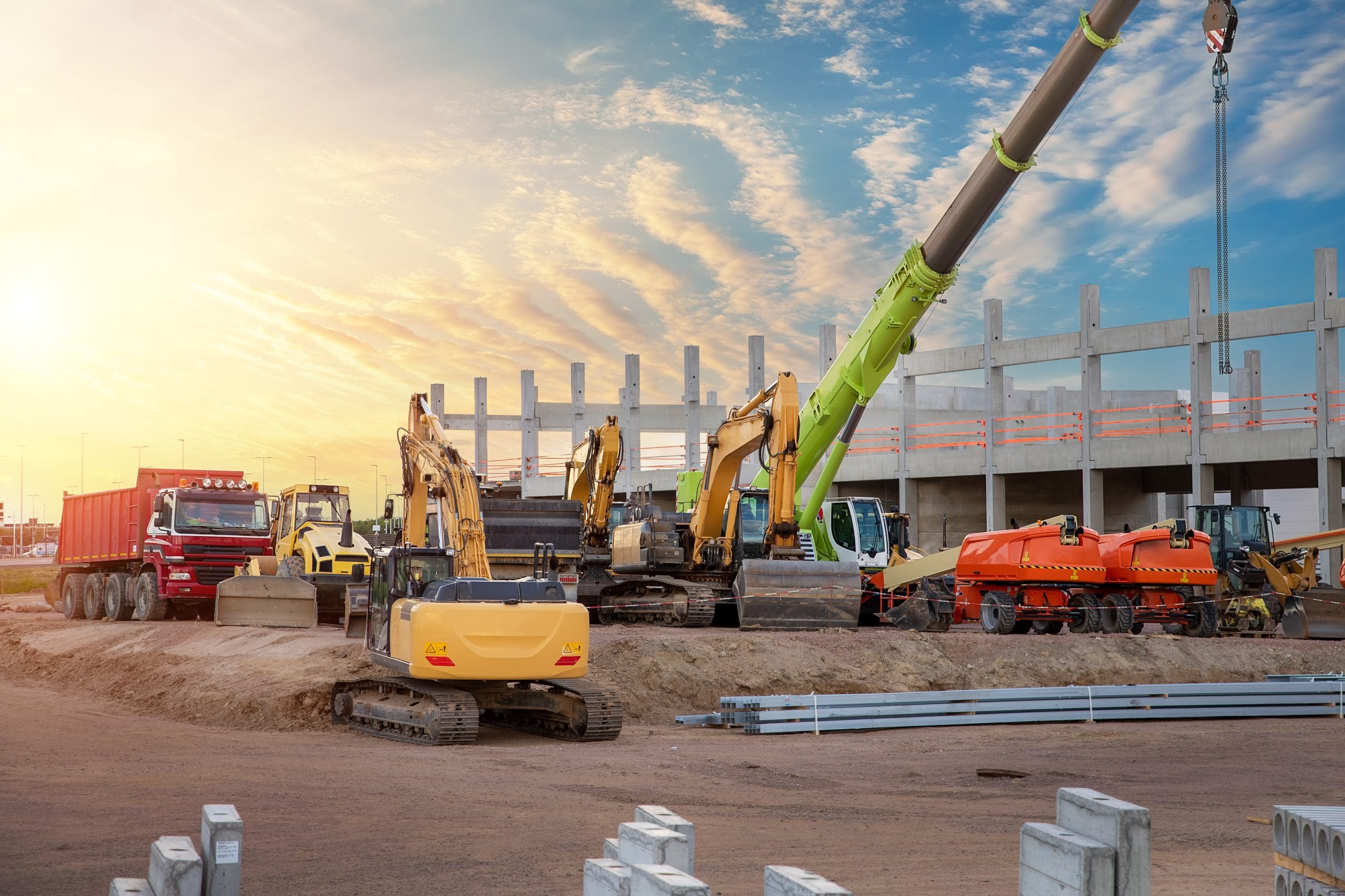 Multiple plant vehicles on a construction site, including excavators, forward tipping dumpers, tractors, diggers and a crane.